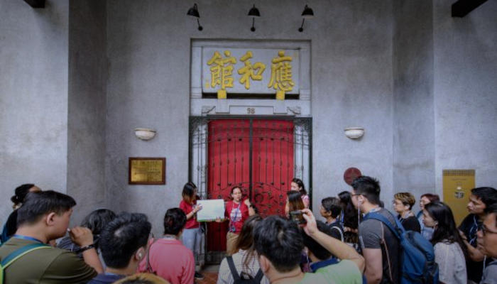 A tour guide is leading a group of participants in a guided walking tour.