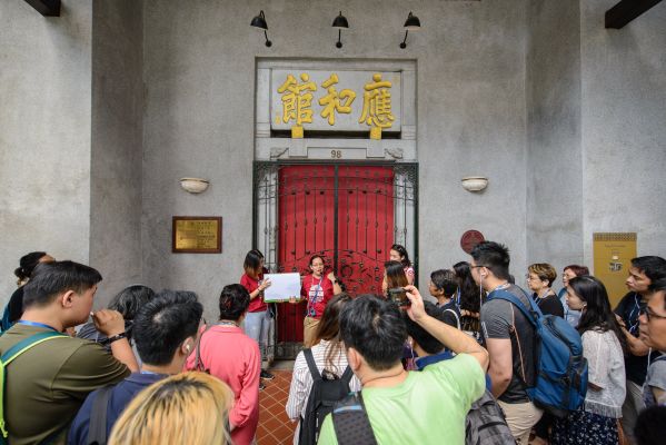 A tour guide is leading a group of participants in a guided walking tour.