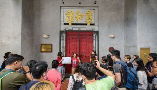 A tour guide is leading a group of participants in a guided walking tour.